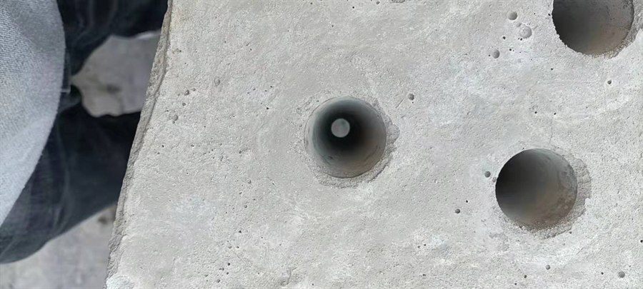 Close-up of drilled holes in a concrete filter plate section