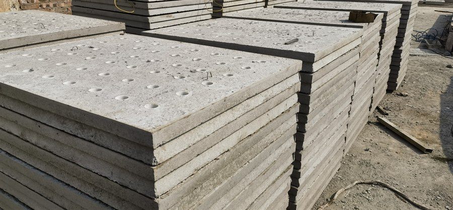 Perforated concrete filter plates stacked in the factory yard
