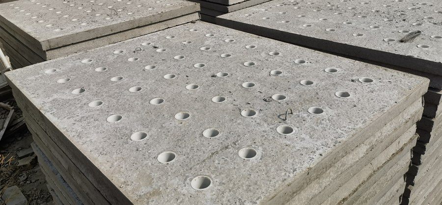 Concrete filter plates with round holes stacked outdoors