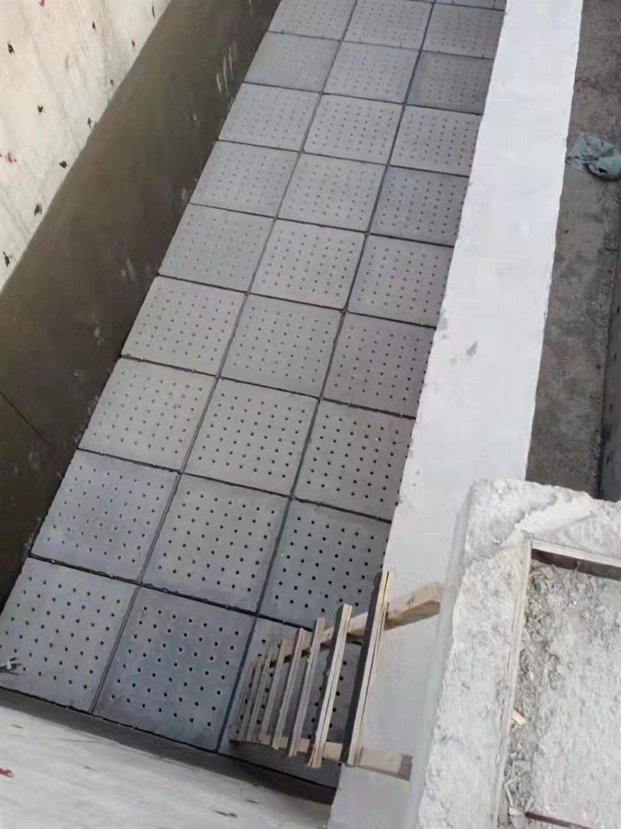 Concrete filter plates bedded on mortar strips inside a filter basin
