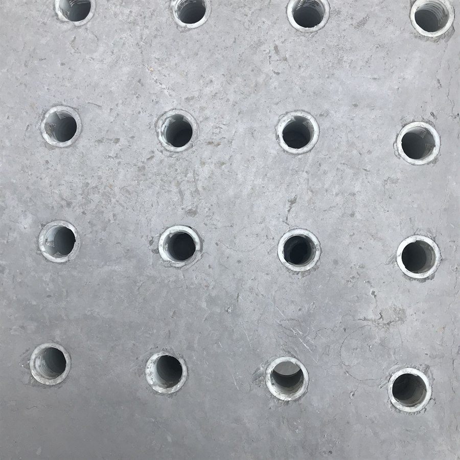 Close-up of the nozzle hole grid in a concrete filter plate