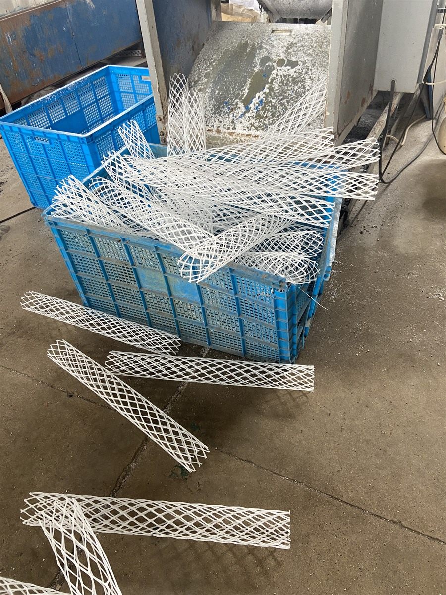 White semi-finished degassing packing elements in a basket on the production floor