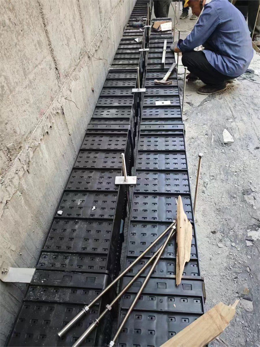Workers fitting filter brick rows on a filter tank floor on site