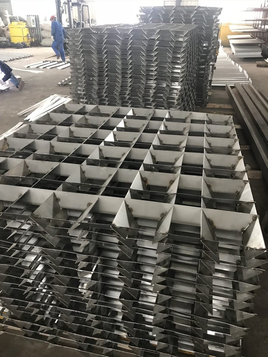 Workers assembling flocculation grid panels in the factory