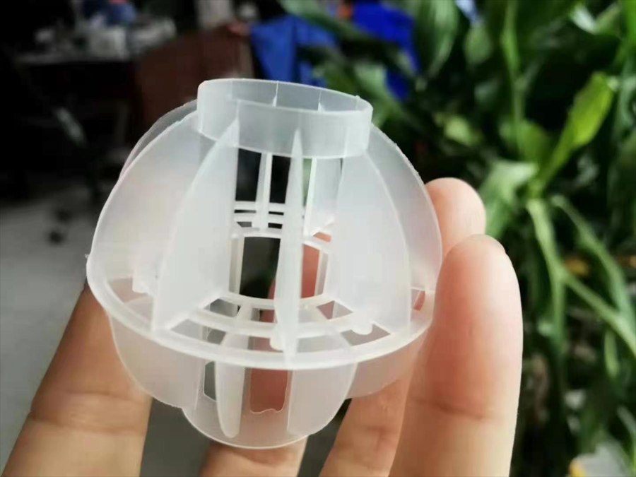 Multi-faceted hollow ball held at a desk