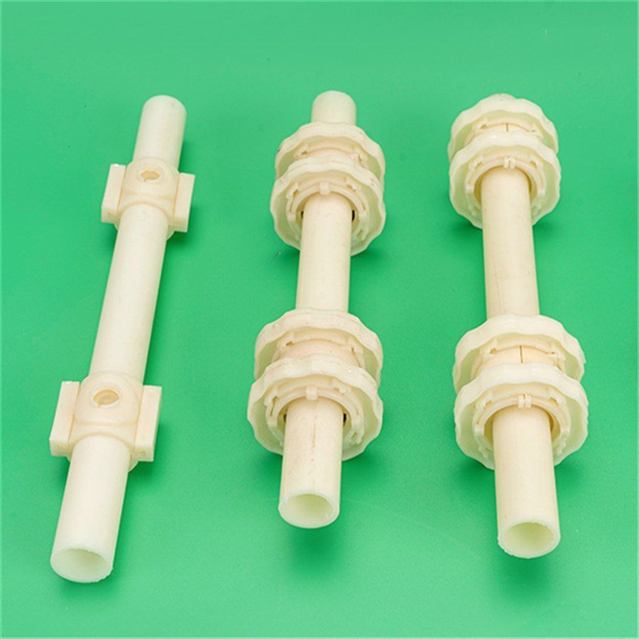 Three single-orifice membrane aerator bodies standing on a green background