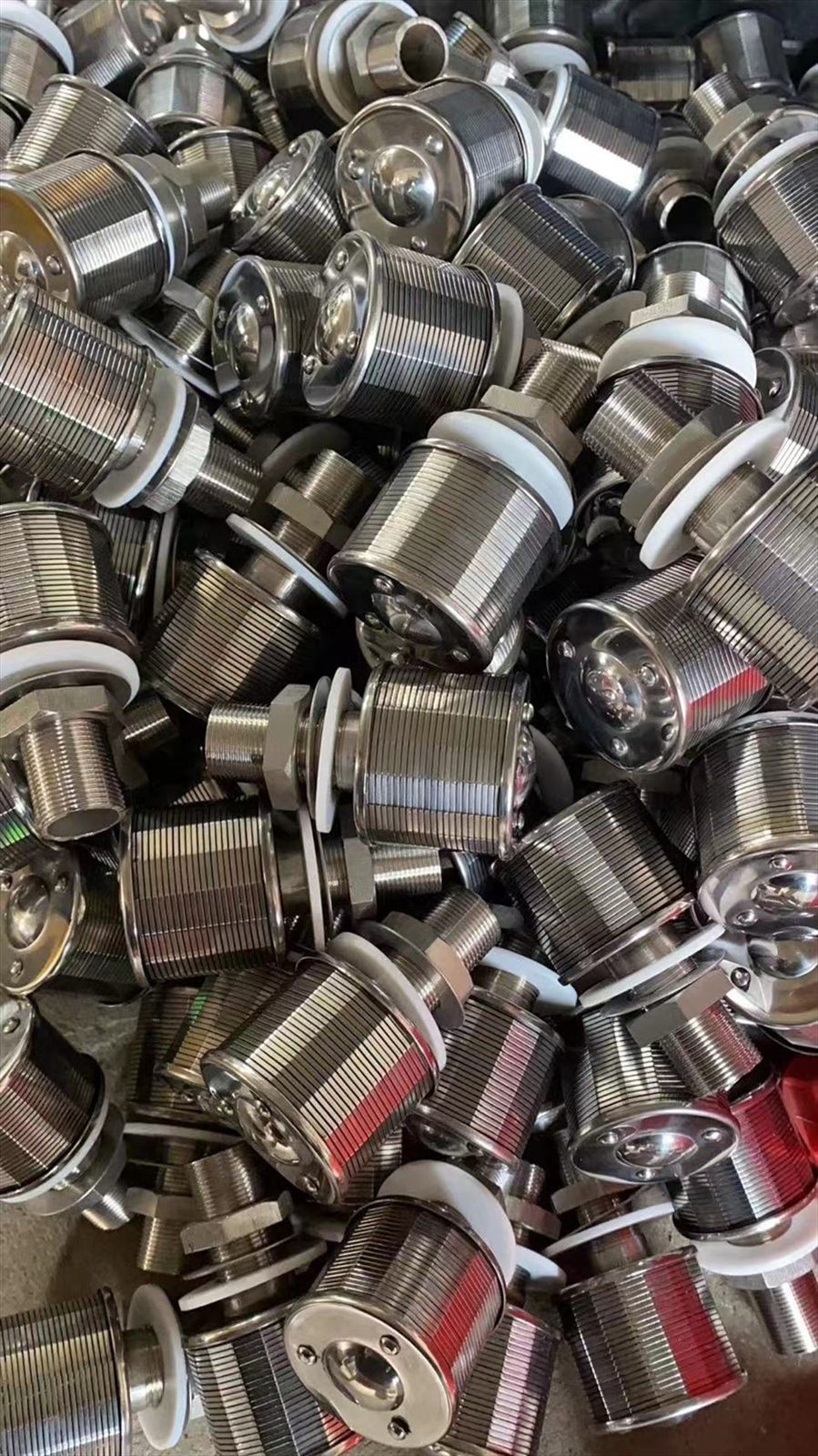 Drain caps packed closely with white sealing washers at the flanges